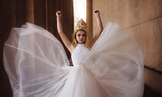 <alt>Greek goddess Athena in white dress wearing couture handmade gold headpiece by Honeydrops Designs</alt>
