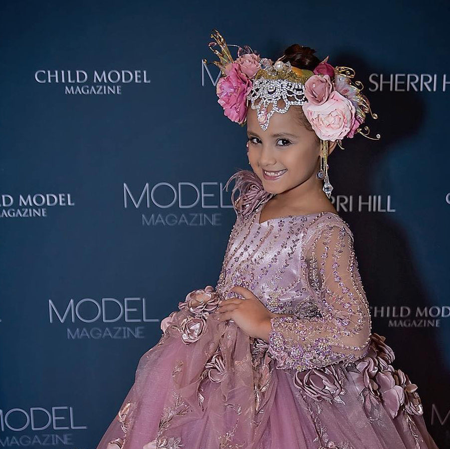 gorgeous little girl wearing custom couture rhinestone headpiece by honeydrops designs and posing on the red carpet