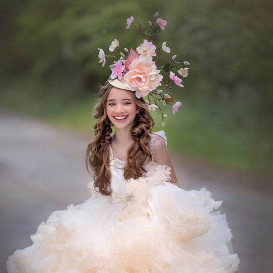 gorgeous girl smiling while wearing a pretty gown and a luxury couture floral headpiece by designer Daniela Mallas of Honeydrops Designs